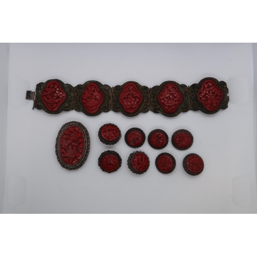 105 - A suite of Chinese cinnabar lacquer jeweller on copper buttons, bracelet and brooch