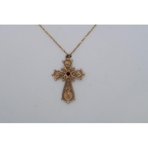 112 - A 9ct yellow gold (hallmarked) filigree cross pendant with red garnet - approx 3.5cm - on a 9ct yell... 