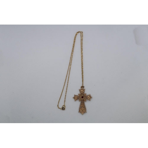 112 - A 9ct yellow gold (hallmarked) filigree cross pendant with red garnet - approx 3.5cm - on a 9ct yell... 