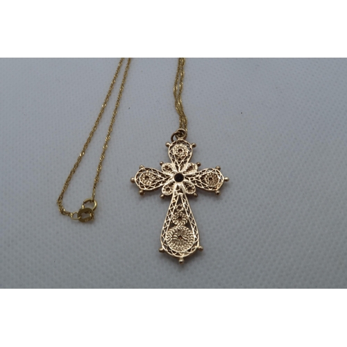 112 - A 9ct yellow gold (hallmarked) filigree cross pendant with red garnet - approx 3.5cm - on a 9ct yell... 