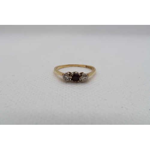 121 - An 18ct yellow gold (hallmarked) three stone ring with diamonds and garnet - ring size L - approx we... 