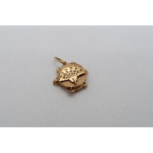 125 - A yellow gold (tested) charm - damaged, tests as approx 18ct - approx weight 2.2 grams