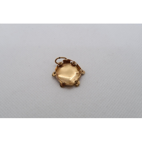 125 - A yellow gold (tested) charm - damaged, tests as approx 18ct - approx weight 2.2 grams