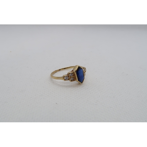 127 - A sapphire (possibly synthetic) ring set in yellow gold (tested as approx 18ct) with diamond set sho... 