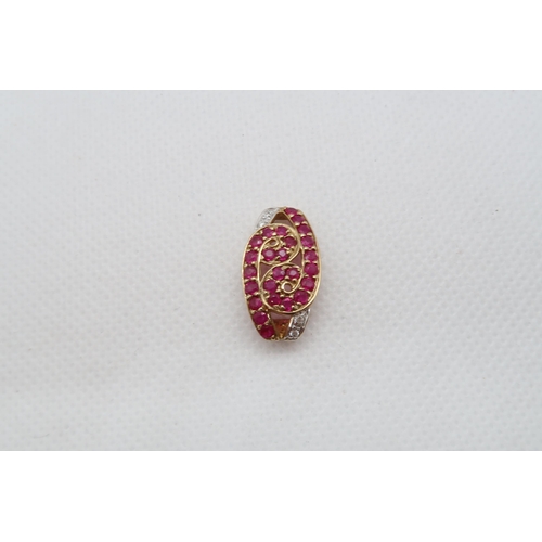 130 - A 9ct yellow gold ruby and diamond pendant - head size 20mm x 12mm