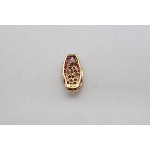 130 - A 9ct yellow gold ruby and diamond pendant - head size 20mm x 12mm