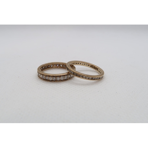 137 - Two 9ct yellow gold (one hallmarked, one tested approx) and diamond eternity rings - sizes M and N -... 