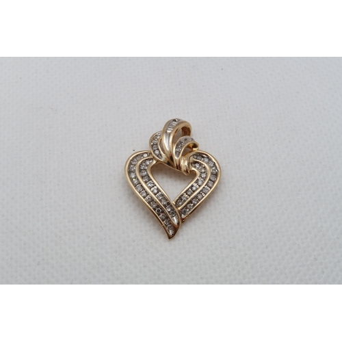 151 - A 14ct yellow gold (hallmarked) heart shaped pendant set with round and baguette diamonds - approx 3... 