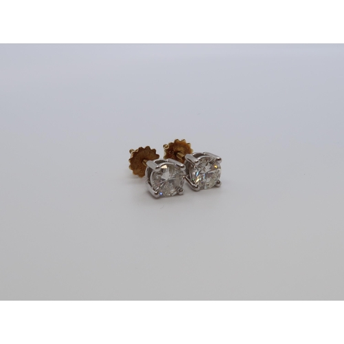 182 - A pair of single stone diamond stud earrings - studs set in 18ct white gold with 18ct yellow gold sc... 