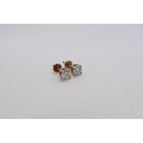 182 - A pair of single stone diamond stud earrings - studs set in 18ct white gold with 18ct yellow gold sc... 