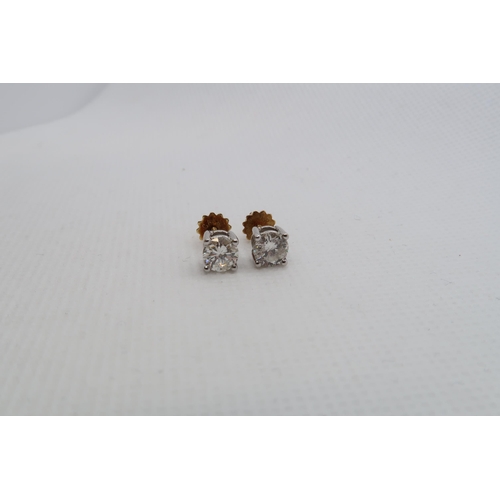 182 - A pair of single stone diamond stud earrings - studs set in 18ct white gold with 18ct yellow gold sc... 