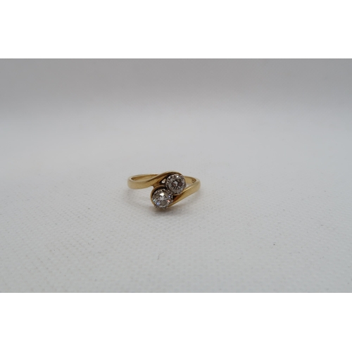 183 - An 18ct yellow gold (hallmarked) diamond two stone crossover ring - round brilliant cut diamonds, to... 