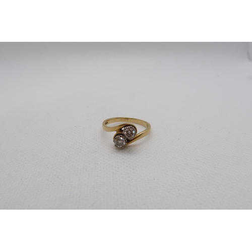 183 - An 18ct yellow gold (hallmarked) diamond two stone crossover ring - round brilliant cut diamonds, to... 