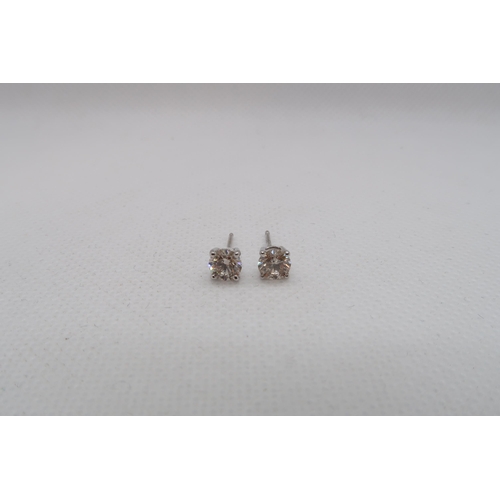 184 - A pair of single stone diamond stud earrings - studs set in 18ct white gold - each round brilliant c... 