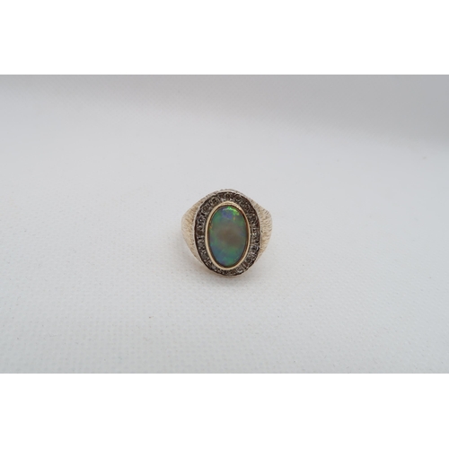 186 - A 9ct yellow gold (hallmarked) opal and diamond ring - the central oval shaped opal approx 12mm x 7m... 