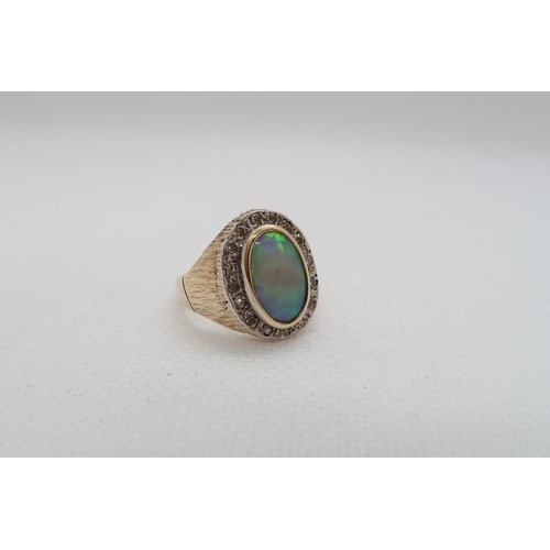 186 - A 9ct yellow gold (hallmarked) opal and diamond ring - the central oval shaped opal approx 12mm x 7m... 