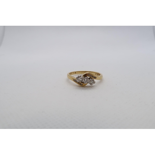 191 - An 18ct yellow gold (hallmarked) three stone diamond ring with diamond set shoulders - ring size V -... 