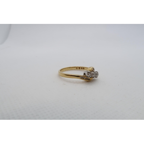 191 - An 18ct yellow gold (hallmarked) three stone diamond ring with diamond set shoulders - ring size V -... 