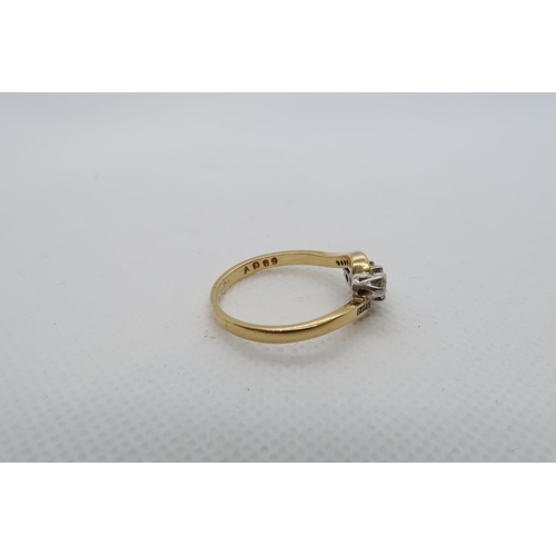 191 - An 18ct yellow gold (hallmarked) three stone diamond ring with diamond set shoulders - ring size V -... 