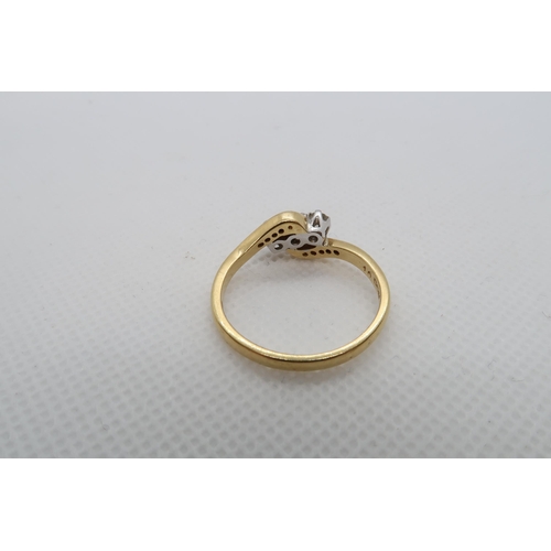 191 - An 18ct yellow gold (hallmarked) three stone diamond ring with diamond set shoulders - ring size V -... 