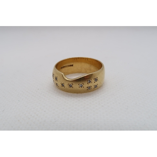 193 - An 18ct yellow gold (hallmarked) band with diamond accents - ring size Q - weight approx 8.7 grams