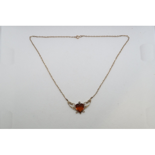 194 - An Edwardian 9ct (hallmarked) necklace with amber heart and seed pearls, pendant length approx 3.5cm... 