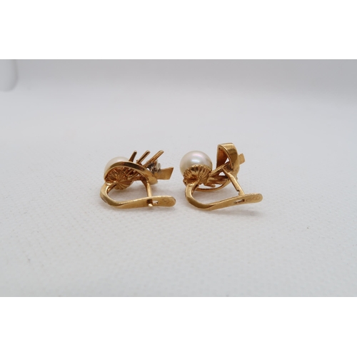 195 - A pair of Continental 18ct yellow gold (hallmarked) earrings with single pearl and diamond accent - ... 