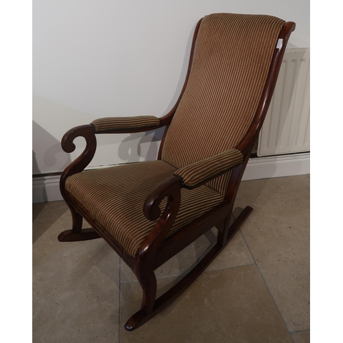 515 - A good quality Victorian mahogany rocking chair upholstered in a stripe fabric - in good condition