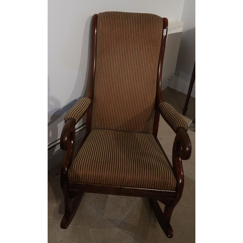 515 - A good quality Victorian mahogany rocking chair upholstered in a stripe fabric - in good condition