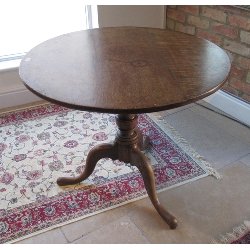 518 - A 19th century oak tripod table - top diameter 86cm