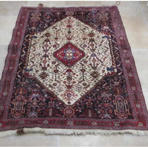 586 - A Persian Qashqai red ground rug - approx 195cm x 155cm