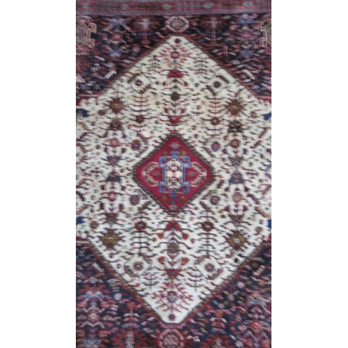 586 - A Persian Qashqai red ground rug - approx 195cm x 155cm