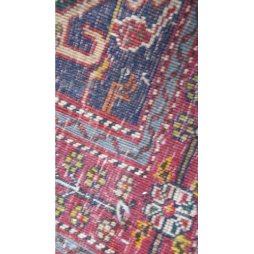 586 - A Persian Qashqai red ground rug - approx 195cm x 155cm