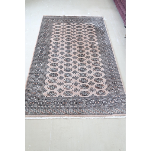 590 - A Khara cream hand knotted woollen rug - 244cm x 155cm - original cost £775 - reasonably good condit... 