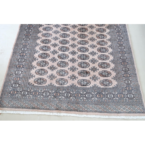 590 - A Khara cream hand knotted woollen rug - 244cm x 155cm - original cost £775 - reasonably good condit... 