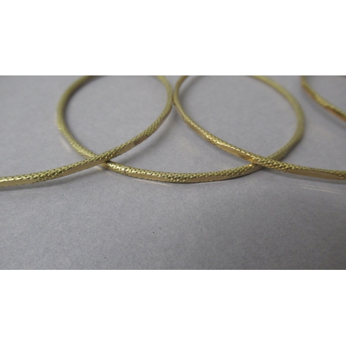 6 - Four yellow gold bangles tested as approx 18ct - diameter approx 6.5cm - approx total weight 27.7 gr... 