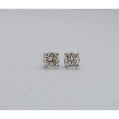 63 - A pair of 18ct white gold solitaire diamond studs, boxed - Round Brilliant Cut diamonds 1.15ct