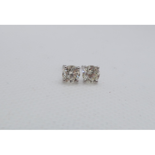 63 - A pair of 18ct white gold solitaire diamond studs, boxed - Round Brilliant Cut diamonds 1.15ct