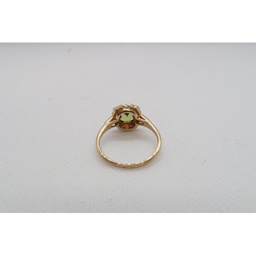 67 - A 9ct yellow gold Peridot and diamond ring with diamond shoulders - head size approx 11mm x 11mm - r... 