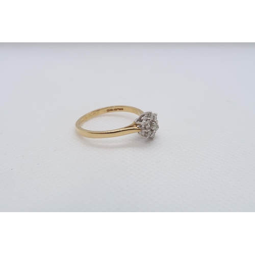 72 - An 18ct yellow gold (hallmarked) and diamond daisy cluster ring size V - approx weight 3.7 grams