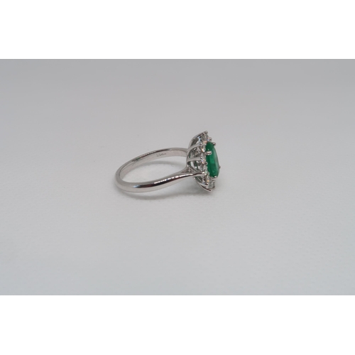 8 - A good platinum (hallmarked) emerald and diamond cluster ring - the central oval emerald approx 1.3c... 