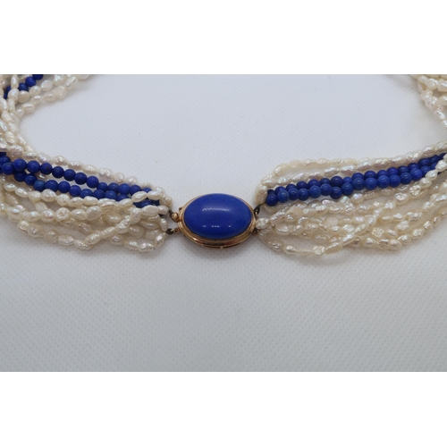 84 - A cultured freshwater pearl and lapis beaded Lapis Lazuli necklace with 9ct gold (hallmarked) oval L... 