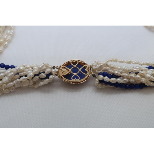 84 - A cultured freshwater pearl and lapis beaded Lapis Lazuli necklace with 9ct gold (hallmarked) oval L... 