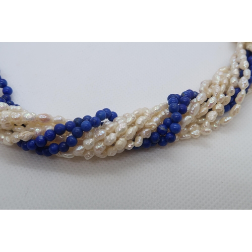 84 - A cultured freshwater pearl and lapis beaded Lapis Lazuli necklace with 9ct gold (hallmarked) oval L... 