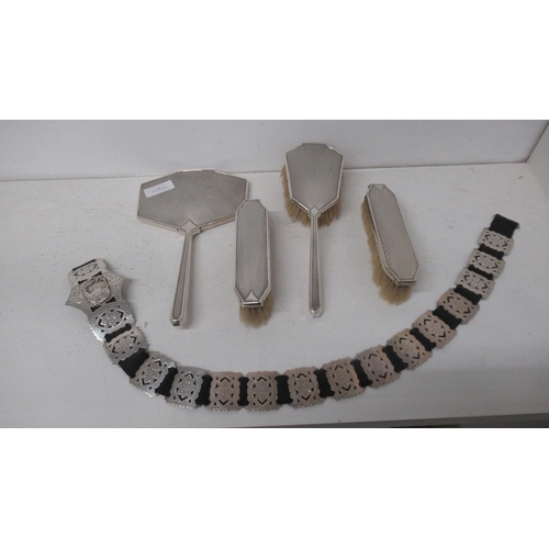 303 - A silver mirror and three brushes and a silver belt