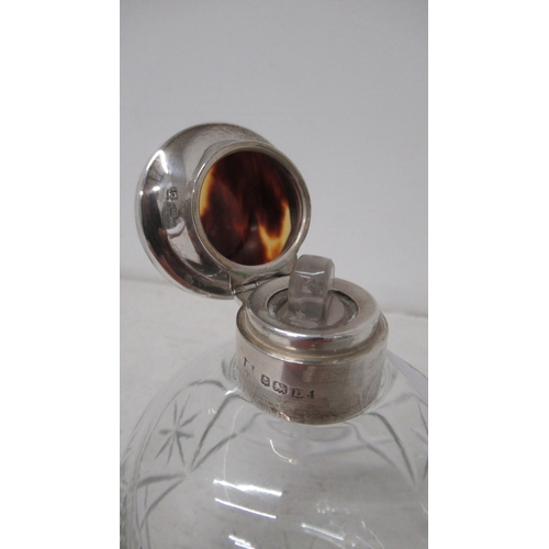 309 - A silver topped cut glass bottle with tortoiseshell and stopper, Birmingham 1928 - good overall cond... 