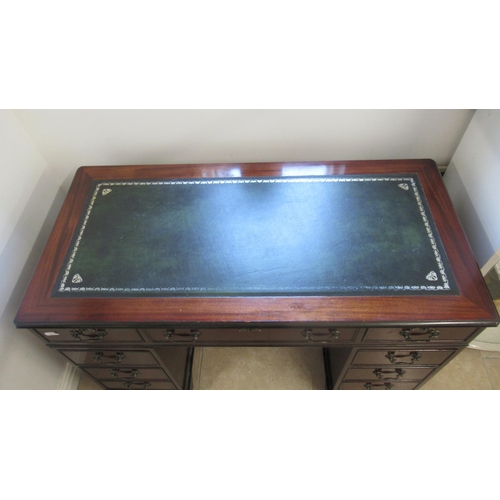 570 - A 20th century mahogany nine drawer desk with an inset top - Width 120cm x Depth 57cm