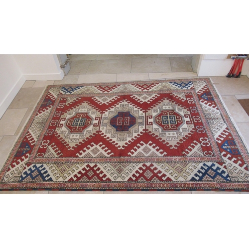 583 - A large hand knotted wool rug - 295cm x 208cm