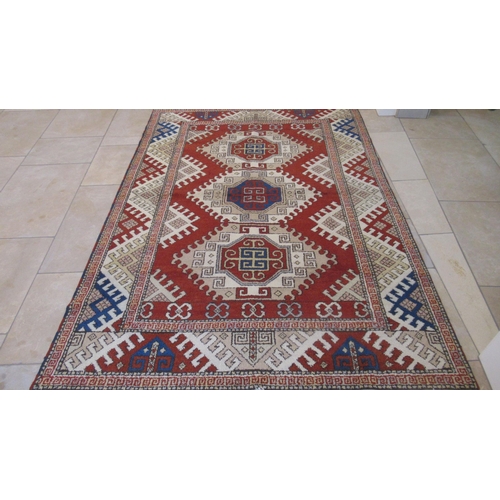 583 - A large hand knotted wool rug - 295cm x 208cm