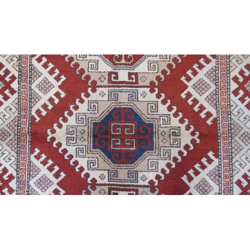 583 - A large hand knotted wool rug - 295cm x 208cm